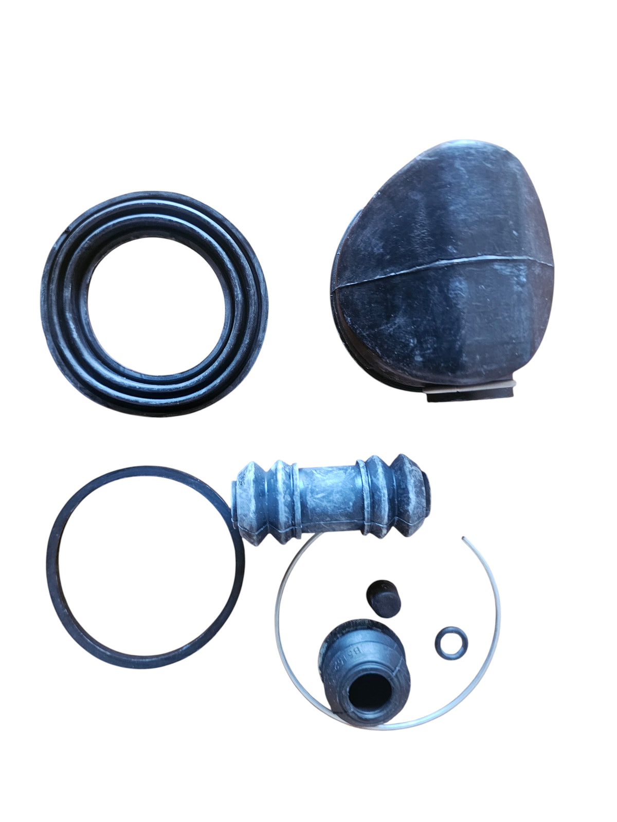 Addicted To Subi front brake caliper seal kit for EA81 Brumby and Leone, featuring black rubber seals and metal rings.